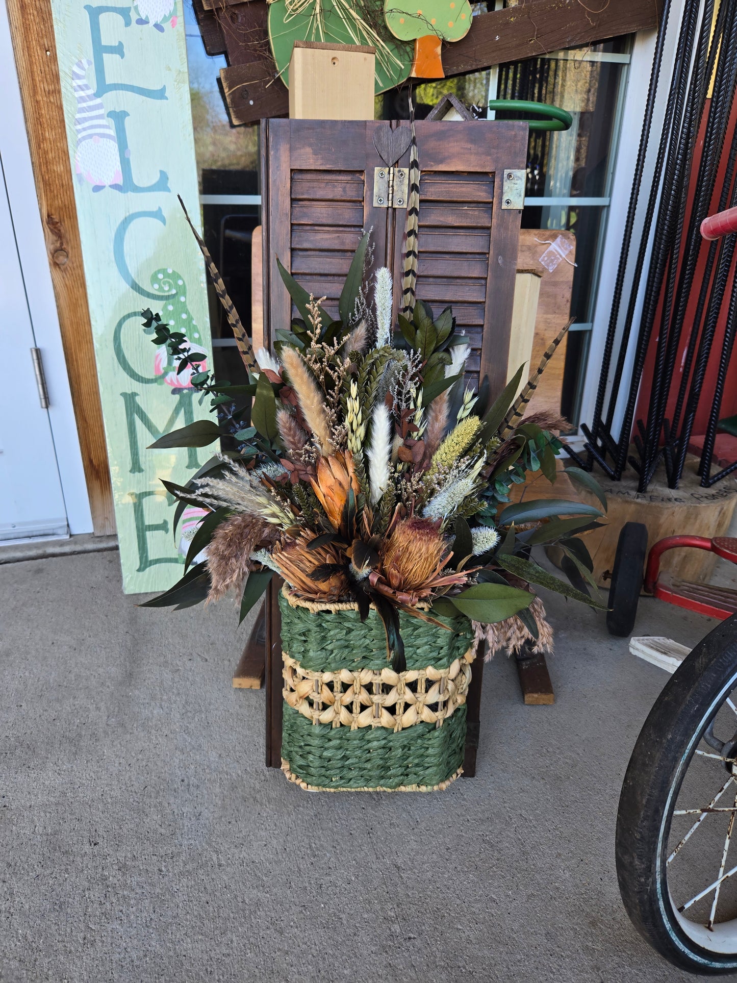 Vintage wood shutter with basket and large arrangement