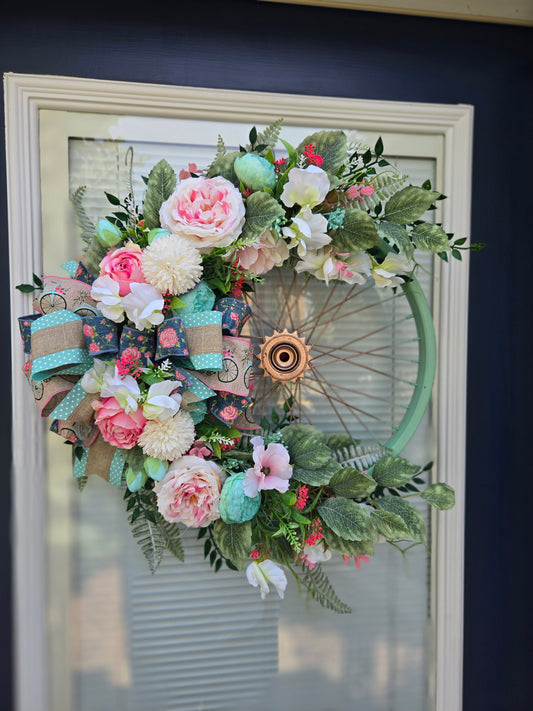 Bicycle wreath with artificial greenery and realistic pink silk flowers